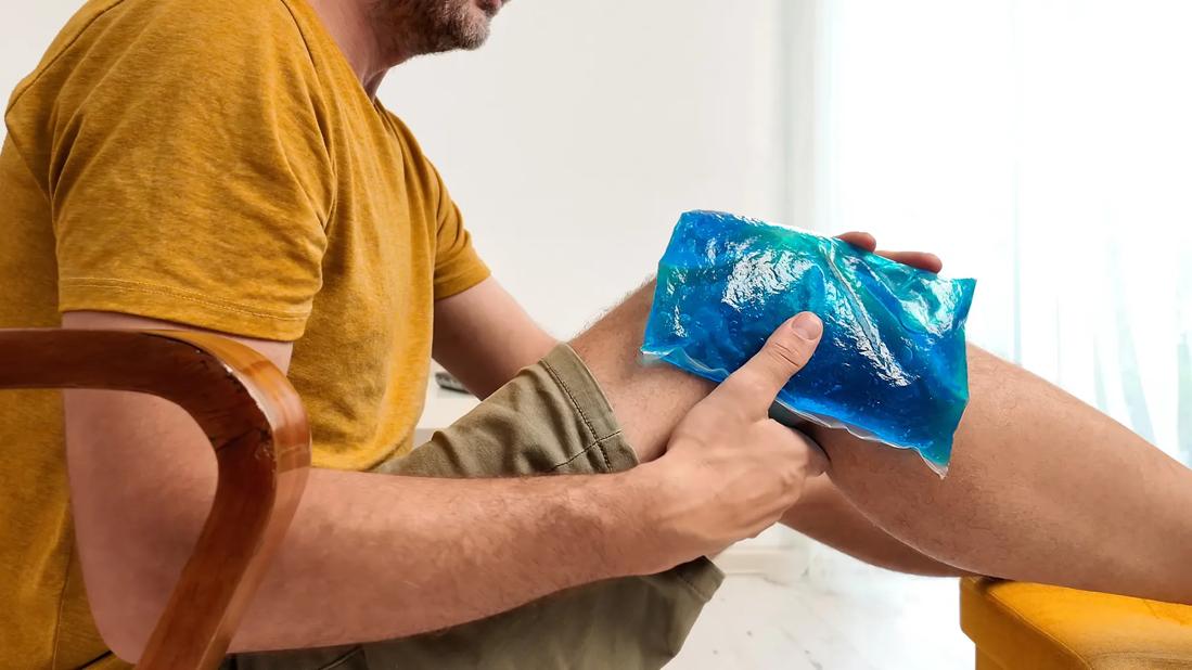 Person icing knee with a cold pack