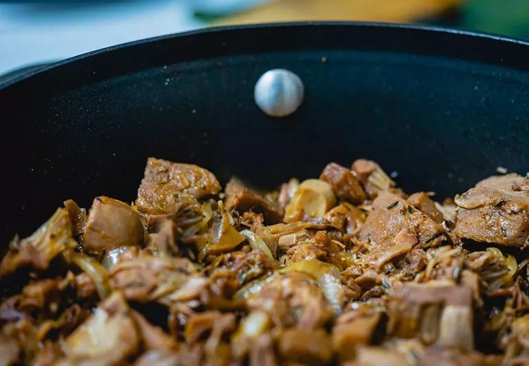 Jackfruit cooked in pan with sweetened sauce added.