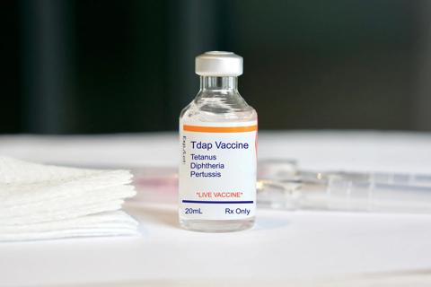 Vial of Tdap vaccine, with gauze pads
